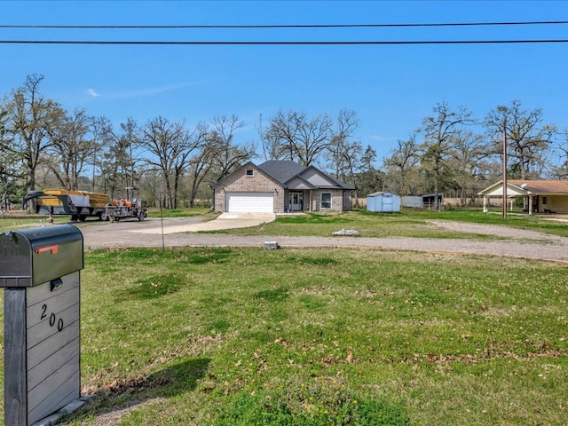 view of yard with a garage and driveway