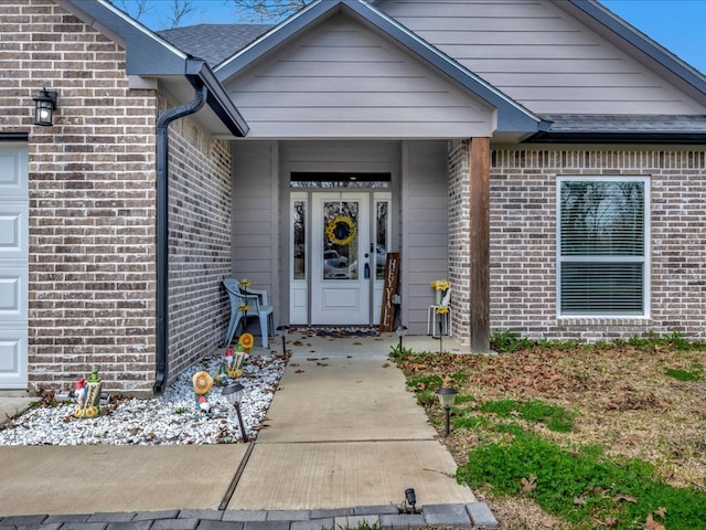 view of exterior entry featuring brick siding