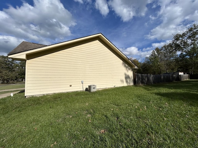 view of property exterior featuring a yard and central AC