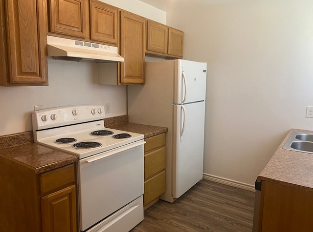 kitchen with sink, dark wood-type flooring, and white appliances