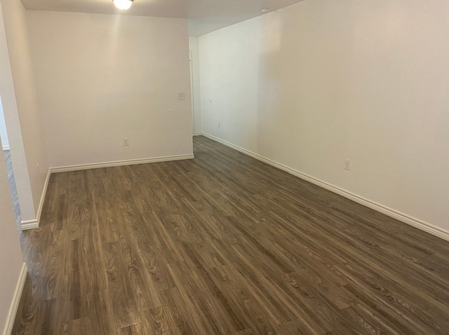 unfurnished room with dark hardwood / wood-style floors