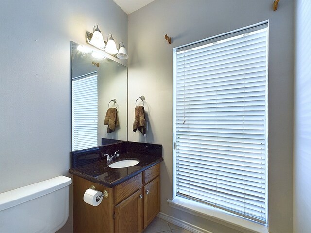 bathroom featuring tile patterned flooring, vanity, and toilet