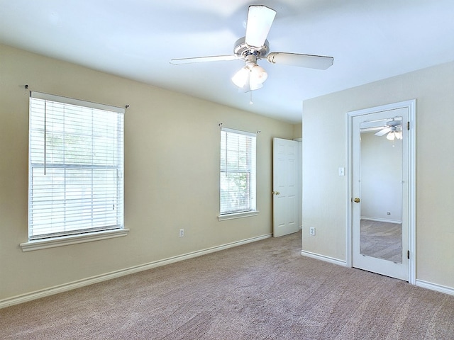 unfurnished bedroom with ceiling fan and light colored carpet