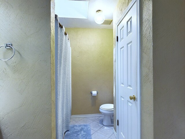 bathroom with tile patterned floors and toilet