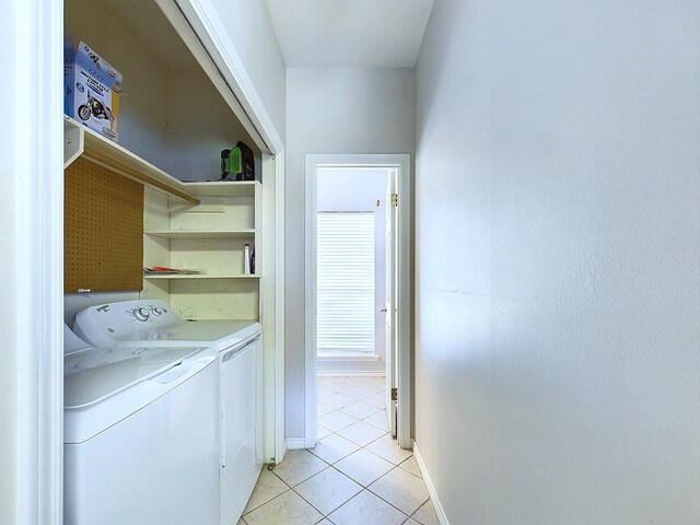 clothes washing area featuring washer and dryer and light tile patterned flooring