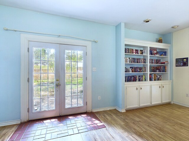 doorway featuring french doors, plenty of natural light, and light hardwood / wood-style flooring