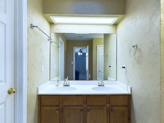 bathroom with ceiling fan and vanity