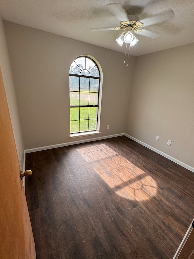393 Rosewood Dr, Jasper, TX 75951 - spare room with dark wood-style flooring, baseboards, and a ceiling fan