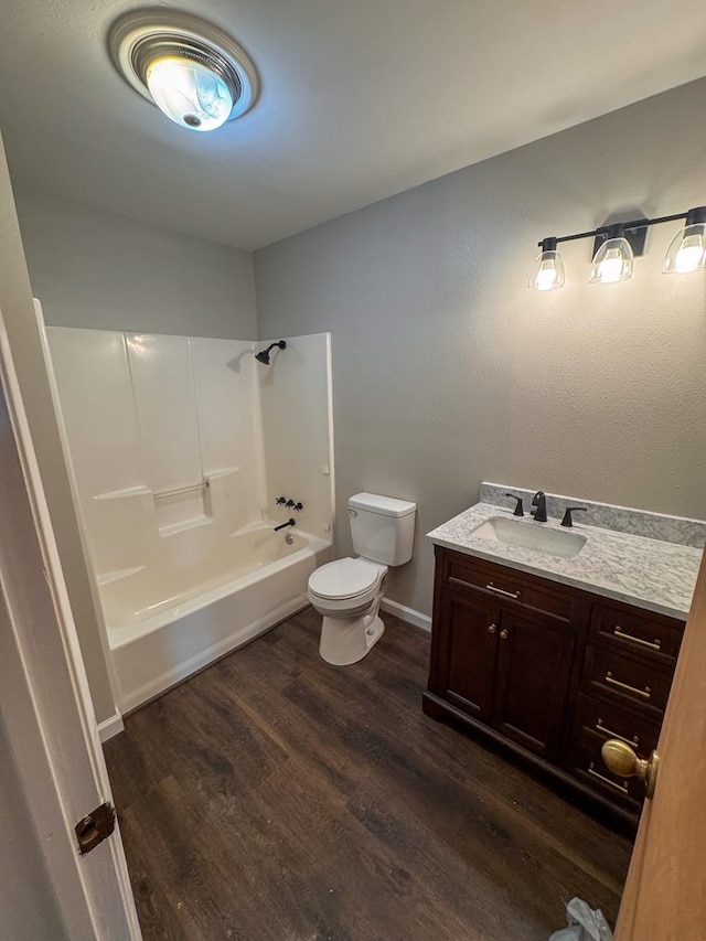 393 Rosewood Dr, Jasper, TX 75951 - full bath with toilet, vanity, wood finished floors, shower / bath combination, and baseboards