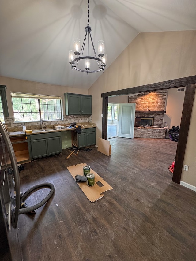 393 Rosewood Dr, Jasper, TX 75951 - living room with a chandelier, a fireplace, dark wood-style flooring, and high vaulted ceiling
