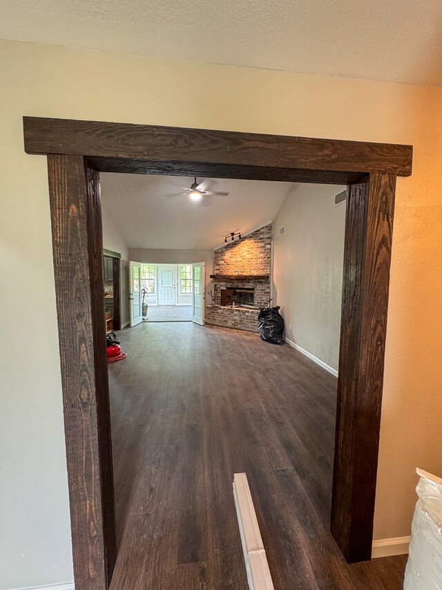 393 Rosewood Dr, Jasper, TX 75951 - unfurnished living room featuring wood finished floors, a fireplace, a ceiling fan, and baseboards