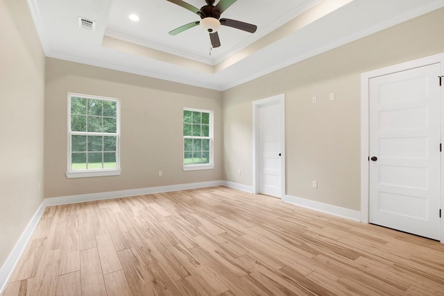 1911 Paul Ave, Lufkin, TX 75901 - spare room with a raised ceiling, light wood-style flooring, ornamental molding, and a ceiling fan