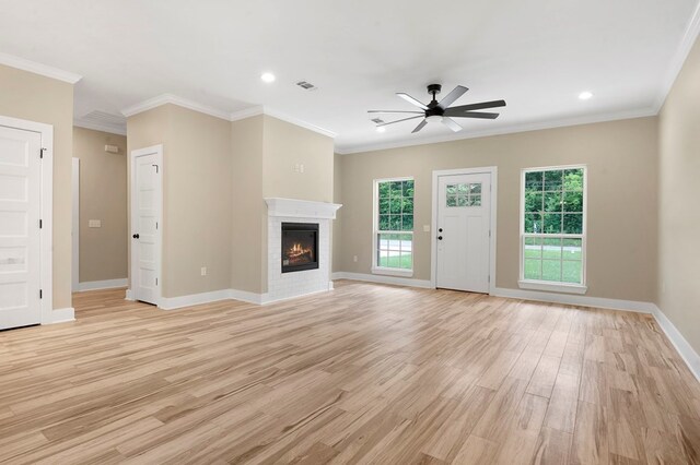 1911 Paul Ave, Lufkin, TX 75901 - unfurnished living room featuring ceiling fan, a glass covered fireplace, light wood-style flooring, recessed lighting, and crown molding