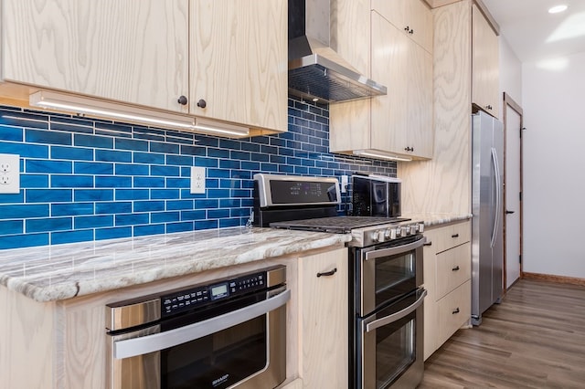 1308 Walnut Bend Dr, Lufkin, TX 75904 - kitchen featuring appliances with stainless steel finishes, wall chimney exhaust hood, light wood-style floors, backsplash, and baseboards