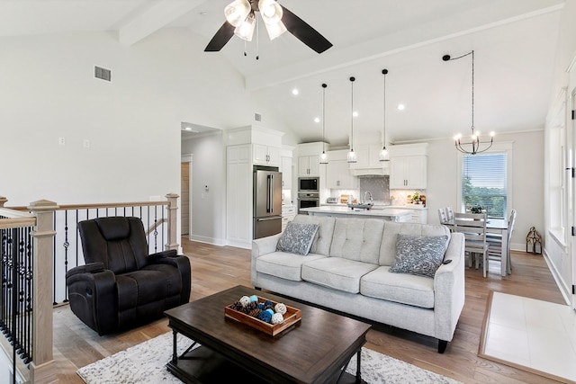 175 Vantage Dr, Brookeland, TX 75931 - living room featuring ceiling fan, beam ceiling, a chandelier, light wood finished floors, and baseboards