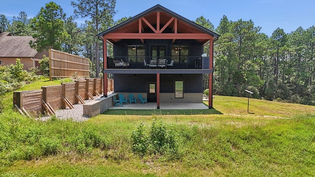 175 Vantage Dr, Brookeland, TX 75931 - back of house featuring a patio area, a lawn, and a balcony