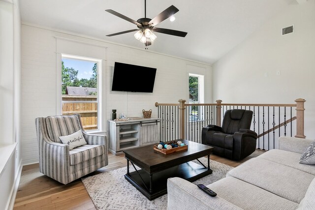 175 Vantage Dr, Brookeland, TX 75931 - living area with light wood-type flooring, ceiling fan, lofted ceiling, brick wall, and baseboards