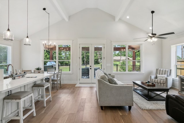 175 Vantage Dr, Brookeland, TX 75931 - living room with french doors, light wood finished floors, beamed ceiling, a chandelier, and high vaulted ceiling