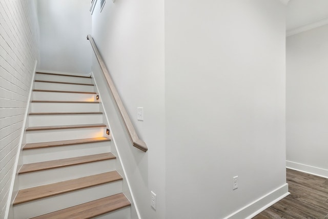 175 Vantage Dr, Brookeland, TX 75931 - staircase with wood finished floors, baseboards, and brick wall