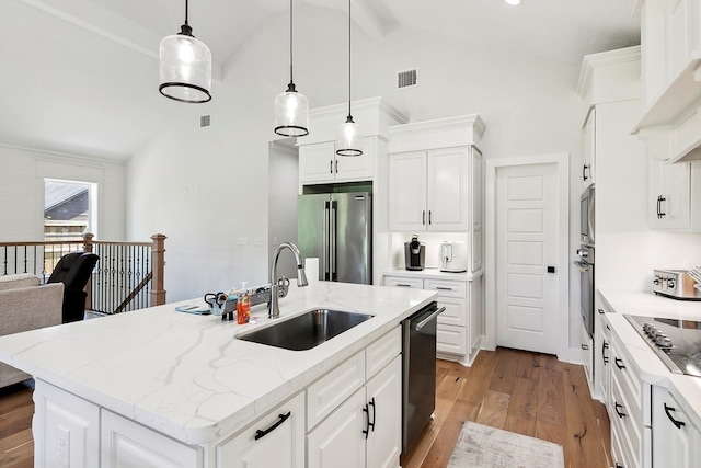 175 Vantage Dr, Brookeland, TX 75931 - kitchen featuring stainless steel appliances, a sink, light wood-style flooring, white cabinets, and high vaulted ceiling