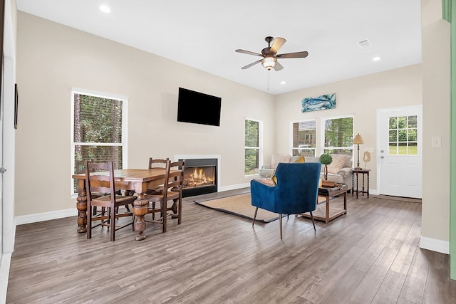 140 Spruce Ln, Brookeland, TX 75931 - living room with wood finished floors, a glass covered fireplace, ceiling fan, and recessed lighting