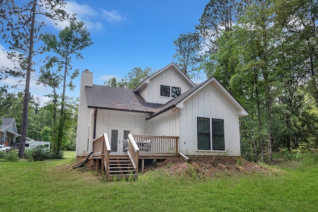 140 Spruce Ln, Brookeland, TX 75931 - back of property featuring french doors, a deck, a yard, roof with shingles, and a chimney