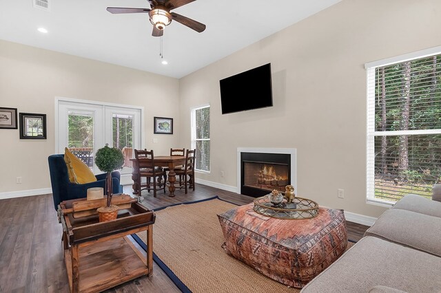 140 Spruce Ln, Brookeland, TX 75931 - living area featuring ceiling fan, dark wood-type flooring, recessed lighting, and a warm lit fireplace