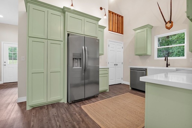 140 Spruce Ln, Brookeland, TX 75931 - kitchen featuring green cabinetry, stainless steel appliances, dark wood finished floors, light countertops, and recessed lighting