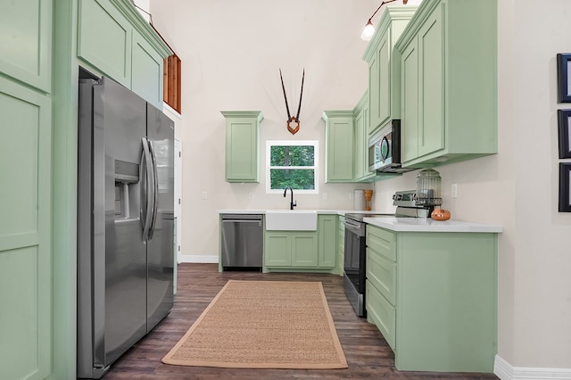 140 Spruce Ln, Brookeland, TX 75931 - kitchen featuring appliances with stainless steel finishes, green cabinets, and dark wood-style floors