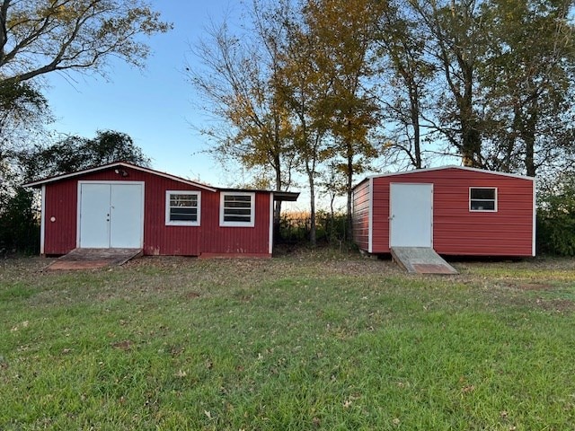 view of outbuilding featuring a yard