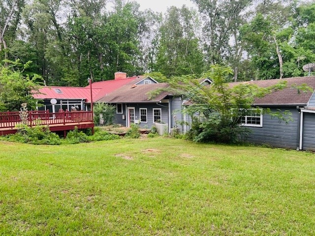 905 Fm 353, San Augustine, TX 75972 - back of house with a lawn, a chimney, a wooden deck, and a garage
