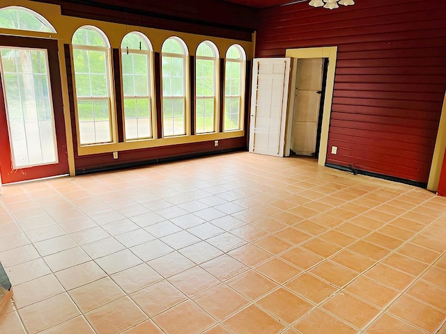 905 Fm 353, San Augustine, TX 75972 - unfurnished room with wooden walls and light tile patterned floors