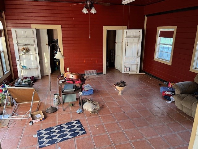 tiled living room featuring ceiling fan