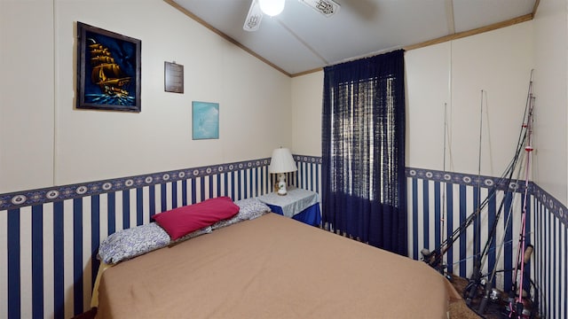 bedroom with crown molding, ceiling fan, and lofted ceiling