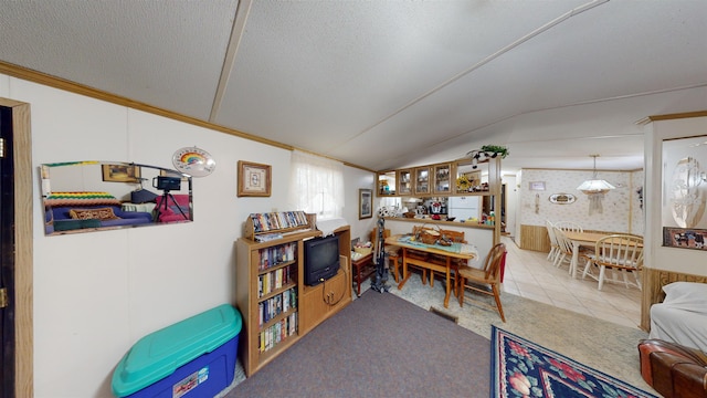 dining area with tile patterned flooring, a textured ceiling, and vaulted ceiling