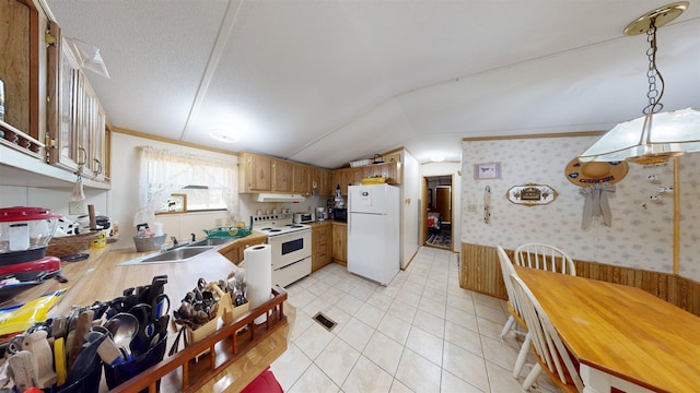 kitchen with white appliances, a textured ceiling, vaulted ceiling, sink, and light tile patterned floors