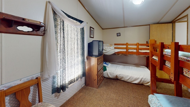 carpeted bedroom with lofted ceiling