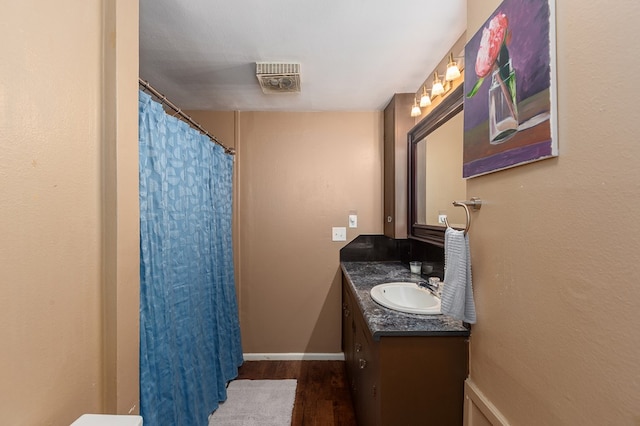 1405 Cimmarron St, Lufkin, TX 75904 - bathroom featuring vanity, wood finished floors, baseboards, and a shower with curtain