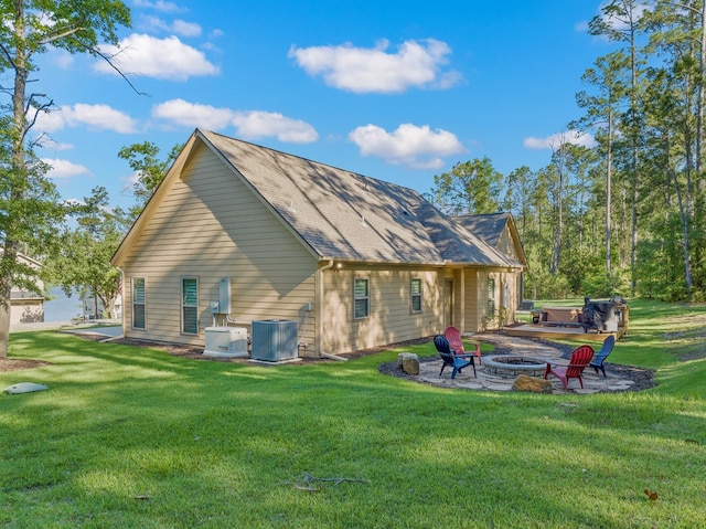 185 Ashley Dr, Brookeland, TX 75931 - rear view of house featuring a fire pit, cooling unit, a yard, and a patio