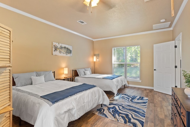 185 Ashley Dr, Brookeland, TX 75931 - bedroom featuring ornamental molding, wood finished floors, a ceiling fan, baseboards, and a textured ceiling