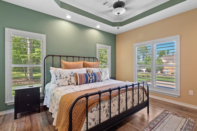 185 Ashley Dr, Brookeland, TX 75931 - bedroom featuring wood finished floors, baseboards, a raised ceiling, ornamental molding, and recessed lighting