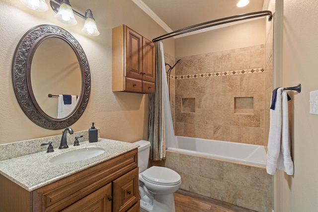 185 Ashley Dr, Brookeland, TX 75931 - bathroom featuring toilet, wood finished floors, tiled shower / bath combo, vanity, and ornamental molding