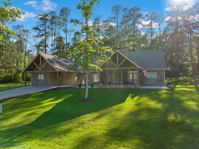185 Ashley Dr, Brookeland, TX 75931 - view of front of house featuring stone siding, a front lawn, a chimney, and a sunroom