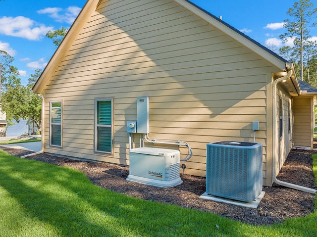 185 Ashley Dr, Brookeland, TX 75931 - back of house with central AC unit and a yard