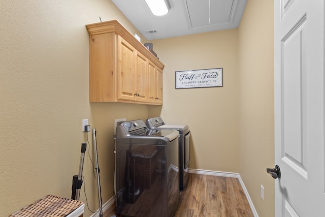 185 Ashley Dr, Brookeland, TX 75931 - laundry area with washing machine and clothes dryer, attic access, wood finished floors, cabinet space, and baseboards