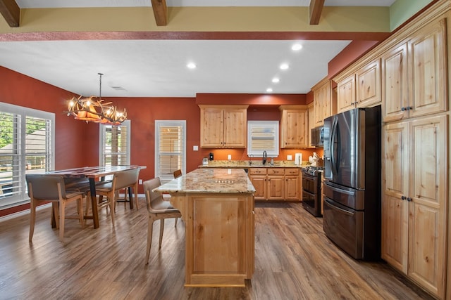 185 Ashley Dr, Brookeland, TX 75931 - kitchen featuring appliances with stainless steel finishes, wood finished floors, beam ceiling, a chandelier, and a kitchen island