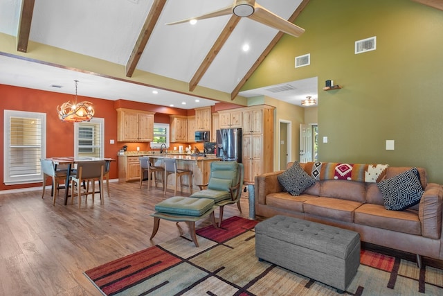 185 Ashley Dr, Brookeland, TX 75931 - living area with high vaulted ceiling, beamed ceiling, light wood finished floors, a ceiling fan, and baseboards