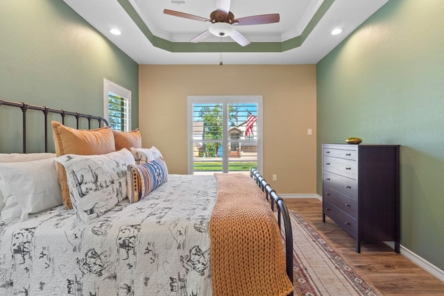 185 Ashley Dr, Brookeland, TX 75931 - bedroom with wood finished floors, a tray ceiling, recessed lighting, a ceiling fan, and baseboards