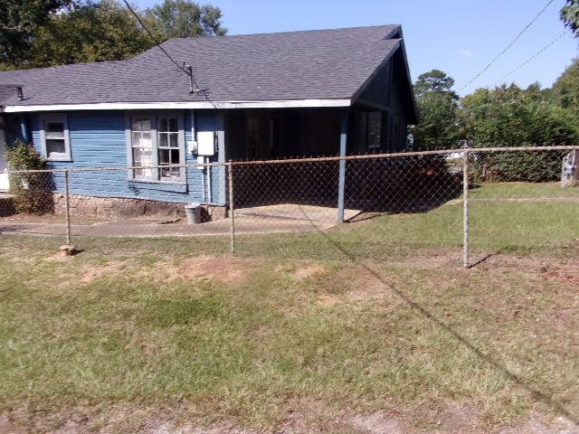 view of property exterior with a lawn