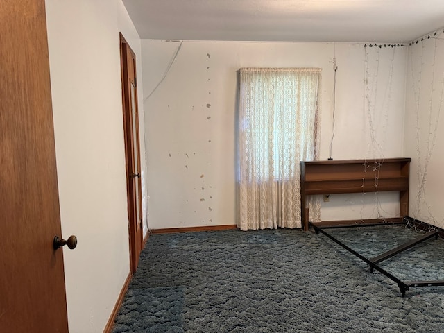 interior space featuring carpet and baseboards